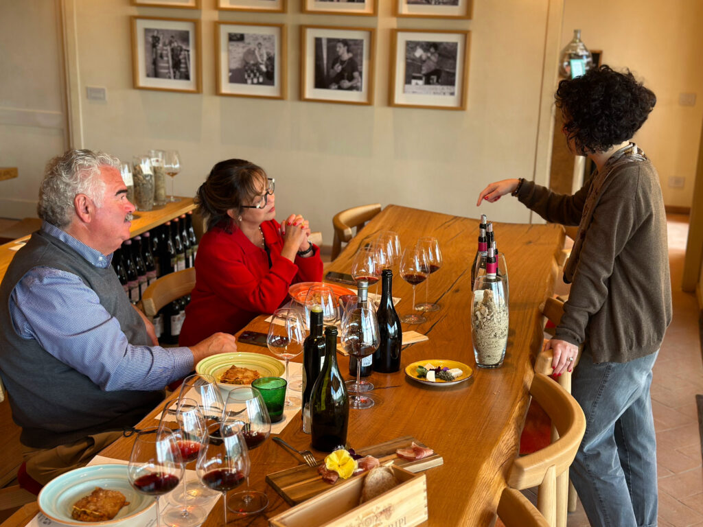 Farm-to-table lunch paired with Brunello di Montalcino wines during a wine tasting tour in Tuscany, set against a rustic backdrop