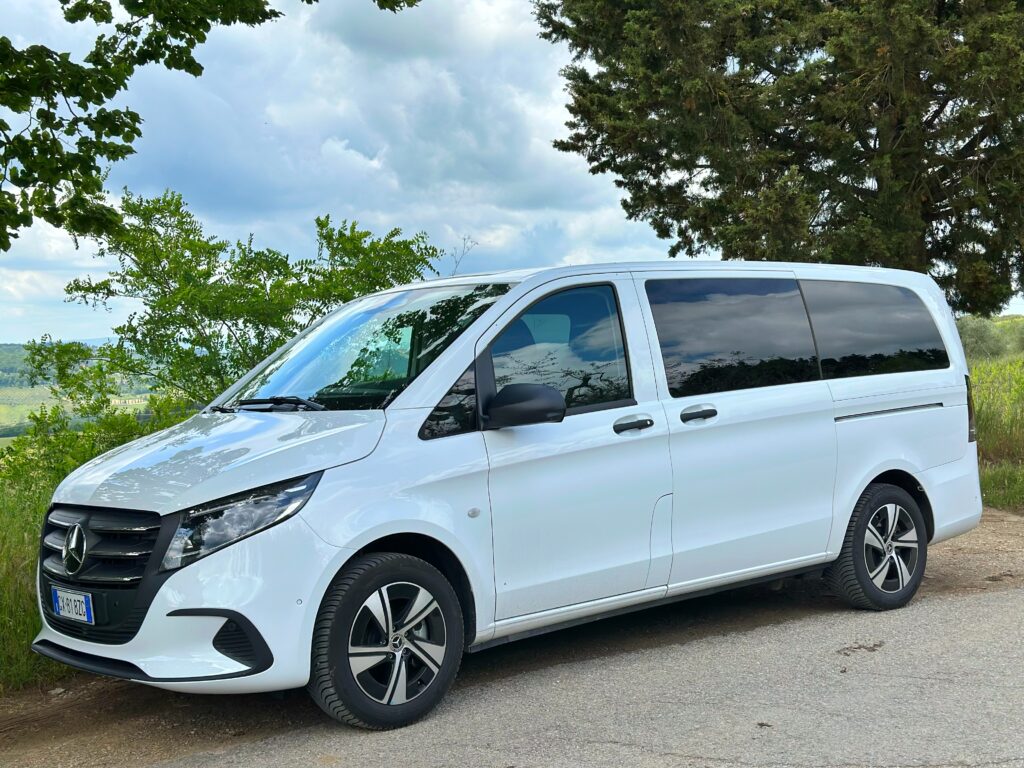White Mercedes van driving from Florence through rolling Carmignano vineyards on the Carmignano Hidden Treasure Tour transfer.