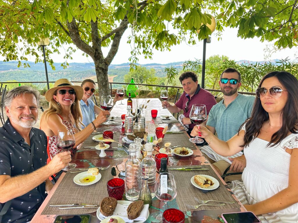 Outdoor farm-to-table lunch paired with Chianti Classico wines during a Tuscany Uncorked wine tasting tour.