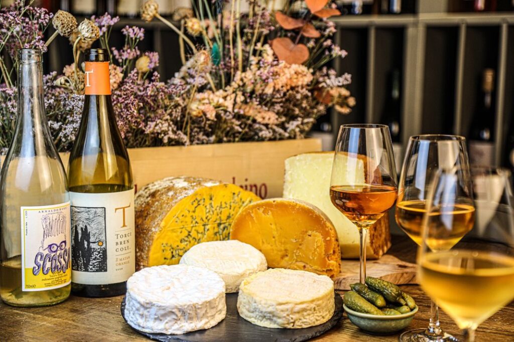 Cheese board and orange wine at Vino al Vino, a top natural wine bar in Florence for authentic tastings