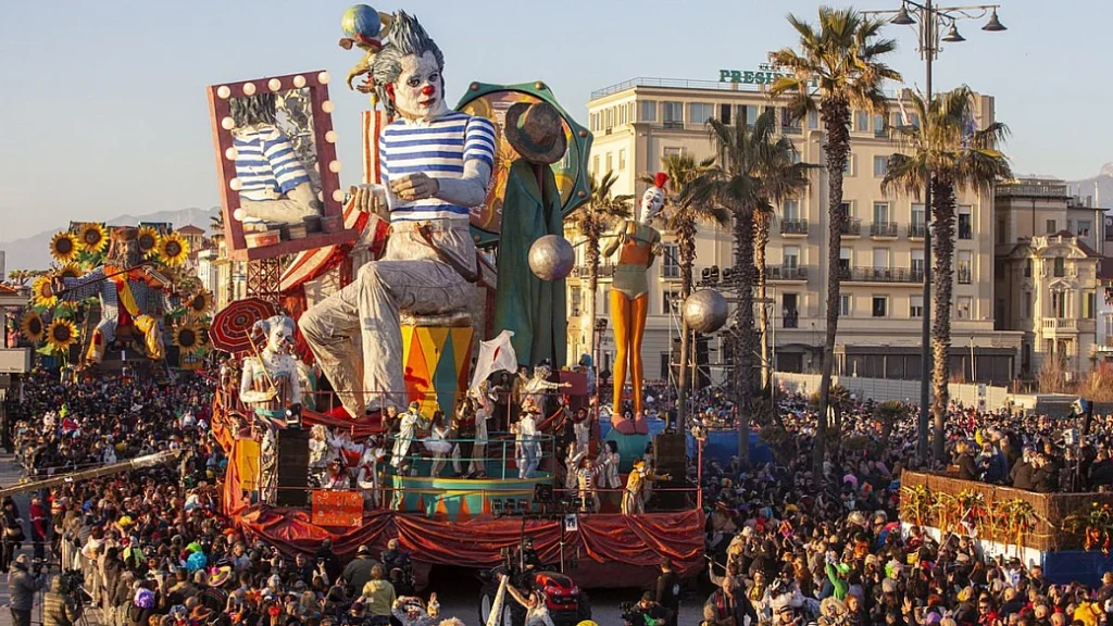 Viareggio Carnival parade float on the Tuscan seafront with crowds watching.