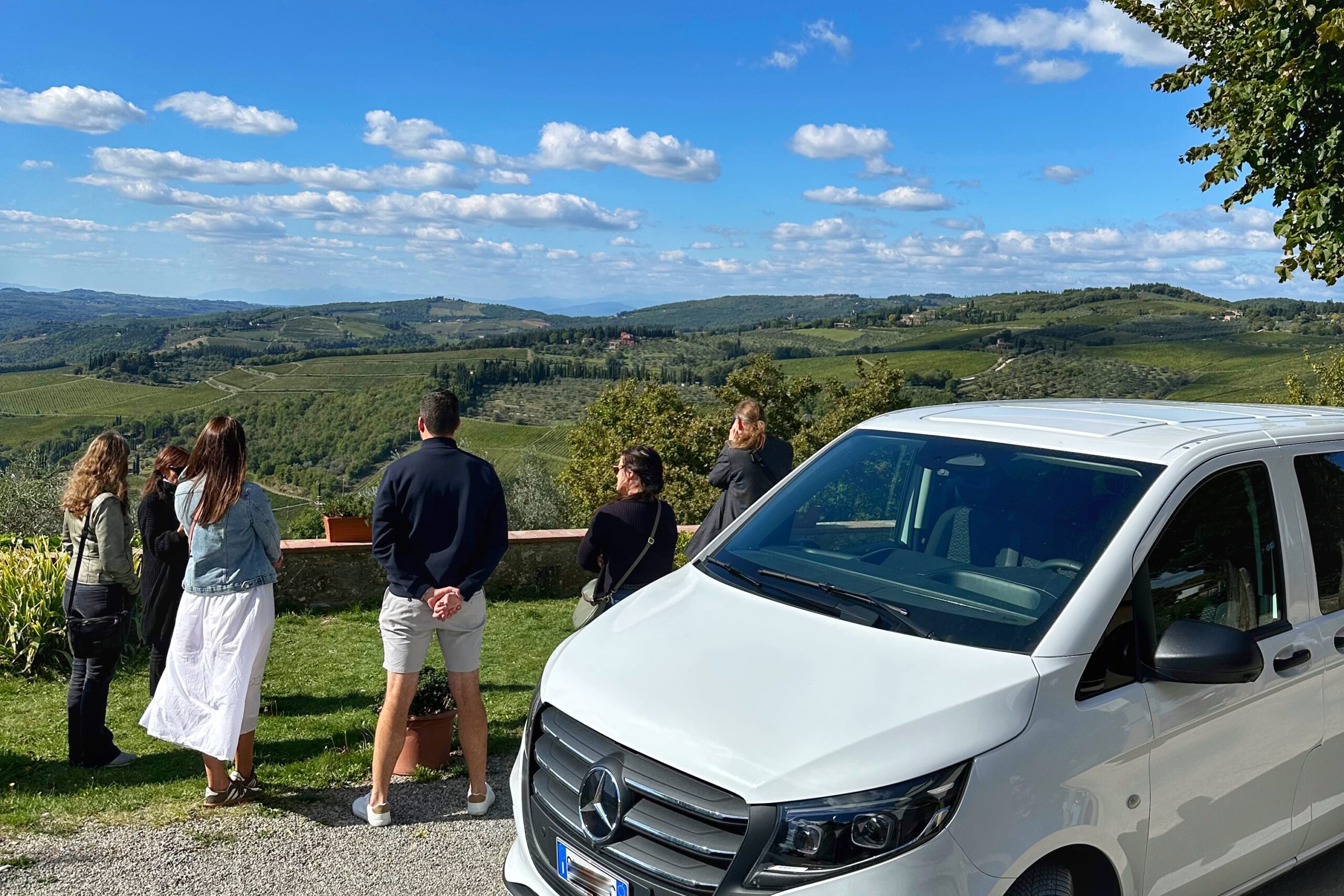Guests admiring the vineyard views in Panzano’s Conca d’Oro during a Tuscany wine tour from Florence, Italy