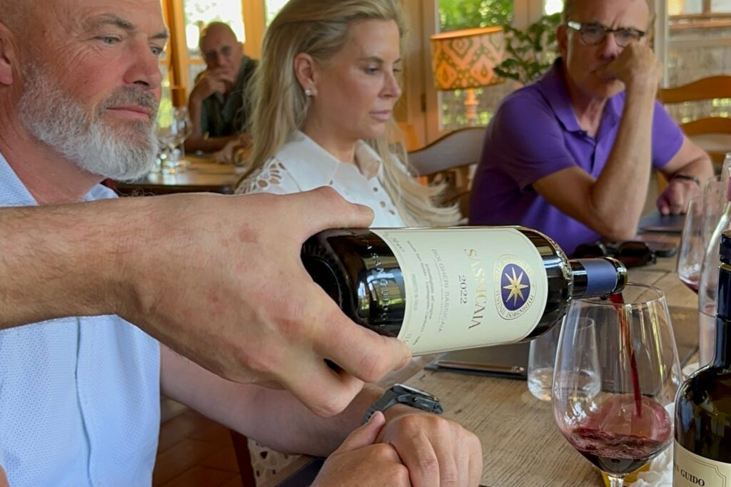 Guests tasting Sassicaia during a private Bolgheri wine tour from Florence, enjoying a premium Super Tuscan tasting experience.