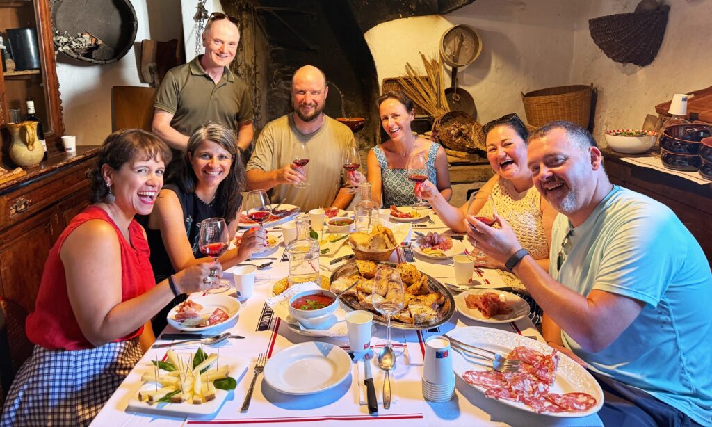 Guests enjoying a memorable guided wine tour in Tuscany with vineyard views, local food, and wine.